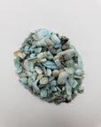 One ounce of larimar stone chips on white background