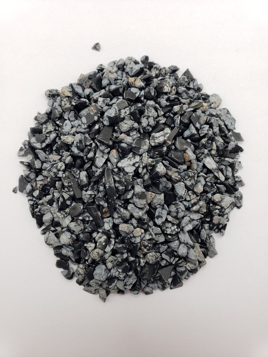 one ounce of snowflake obsidian stone chips on white background