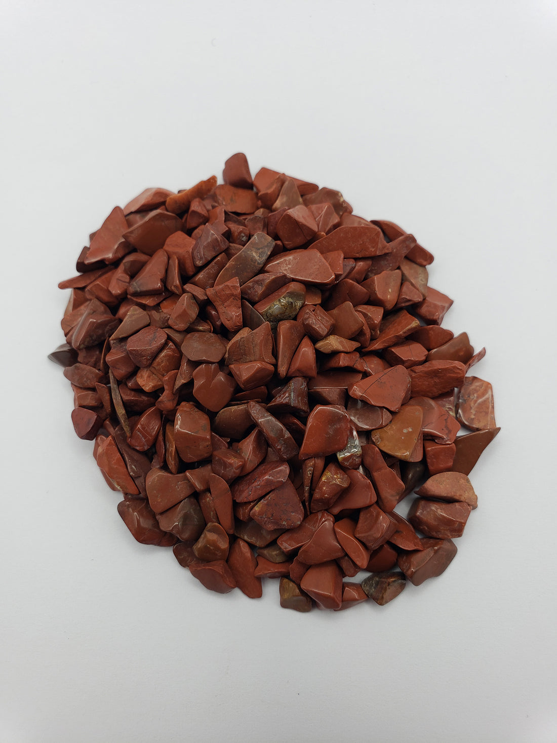 red jasper stone chips on white background