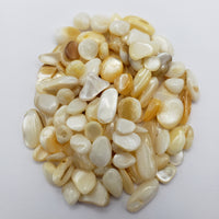 1 ounce of mother of pearl chips on white background