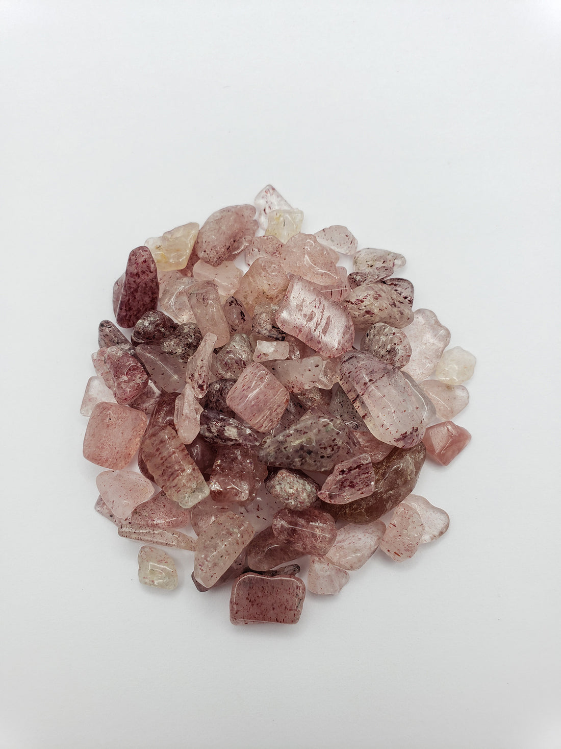 one ounce of strawberry quartz chips on white background