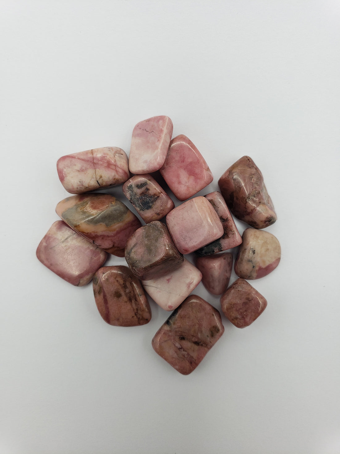 One ounce of rhodonite crystals on white background