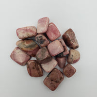 One ounce of rhodonite crystals on white background