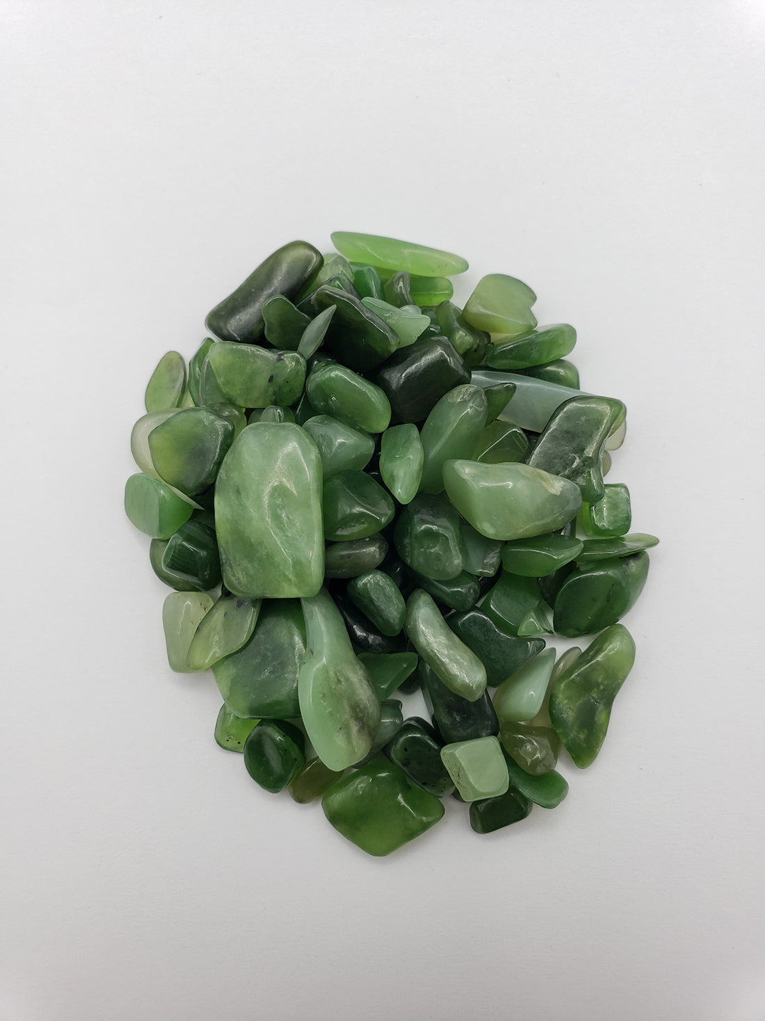 One ounce of nephrite jade chips on white background