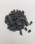 rough shungite stone chips on white background