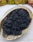 rough shungite stone chips in abalone shell