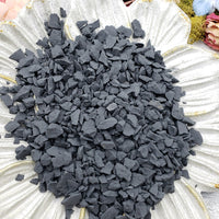 rough shungite stone chips on floral dish display
