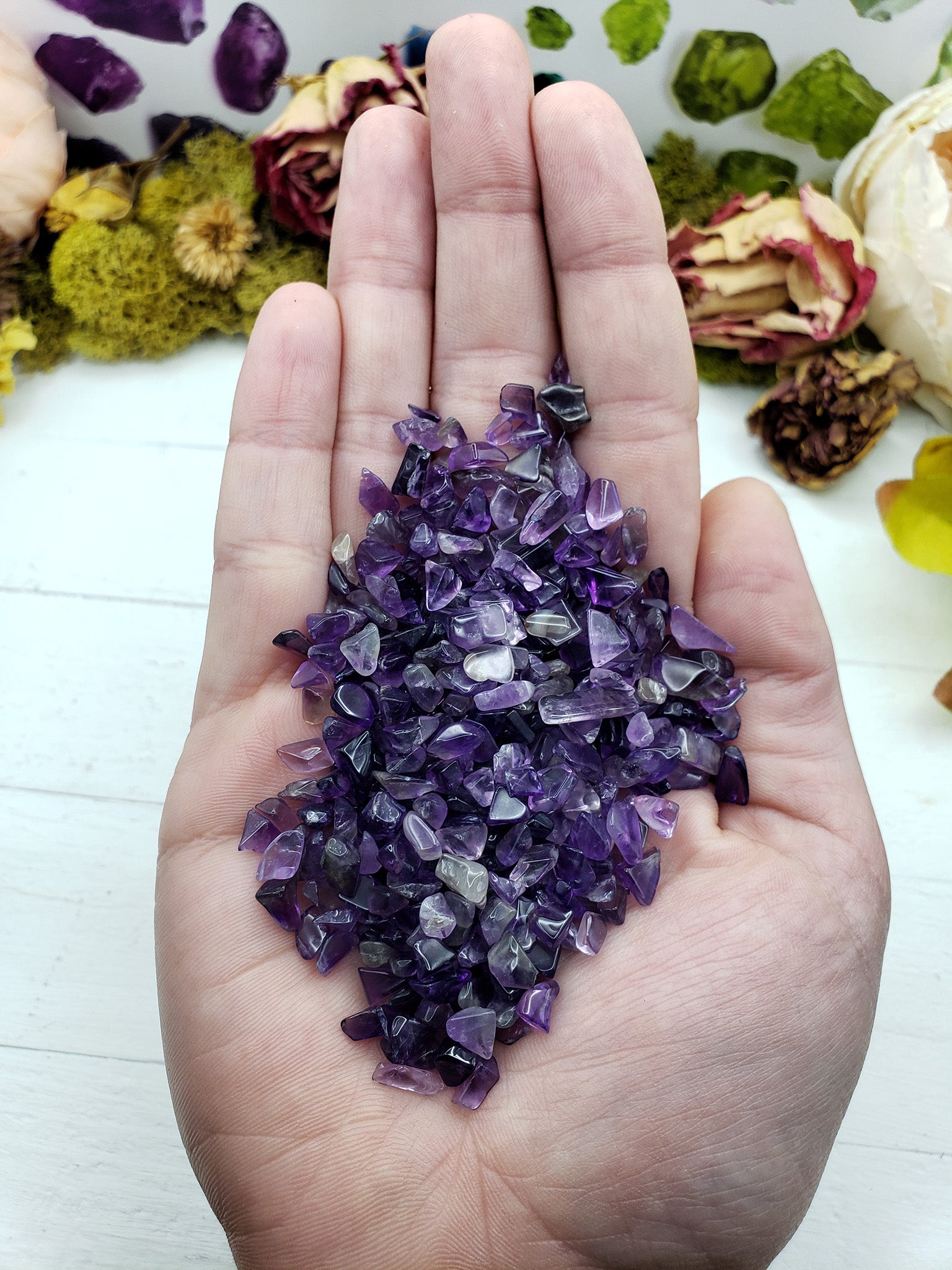 hand holding two ounces of amethyst crystal chips