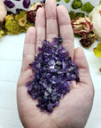 hand holding two ounces of amethyst crystal chips