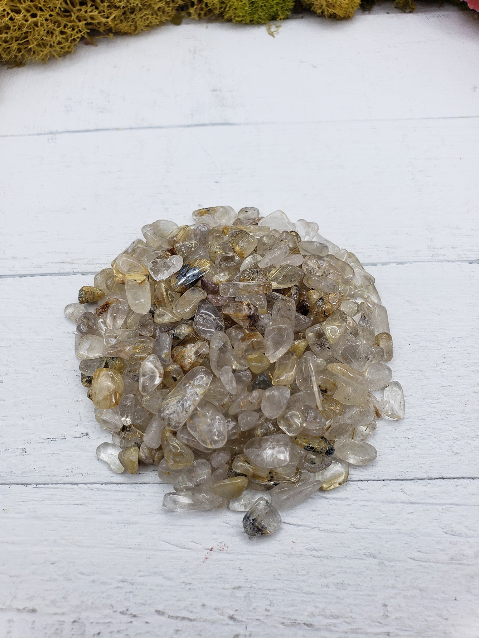 Two ounce gold rutile quartz chips on display