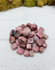 Two ounces of pebble-sized rhodonite crystals on display 