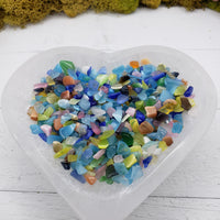 2 ounces of rainbow cats eye stone chips in selenite bowl