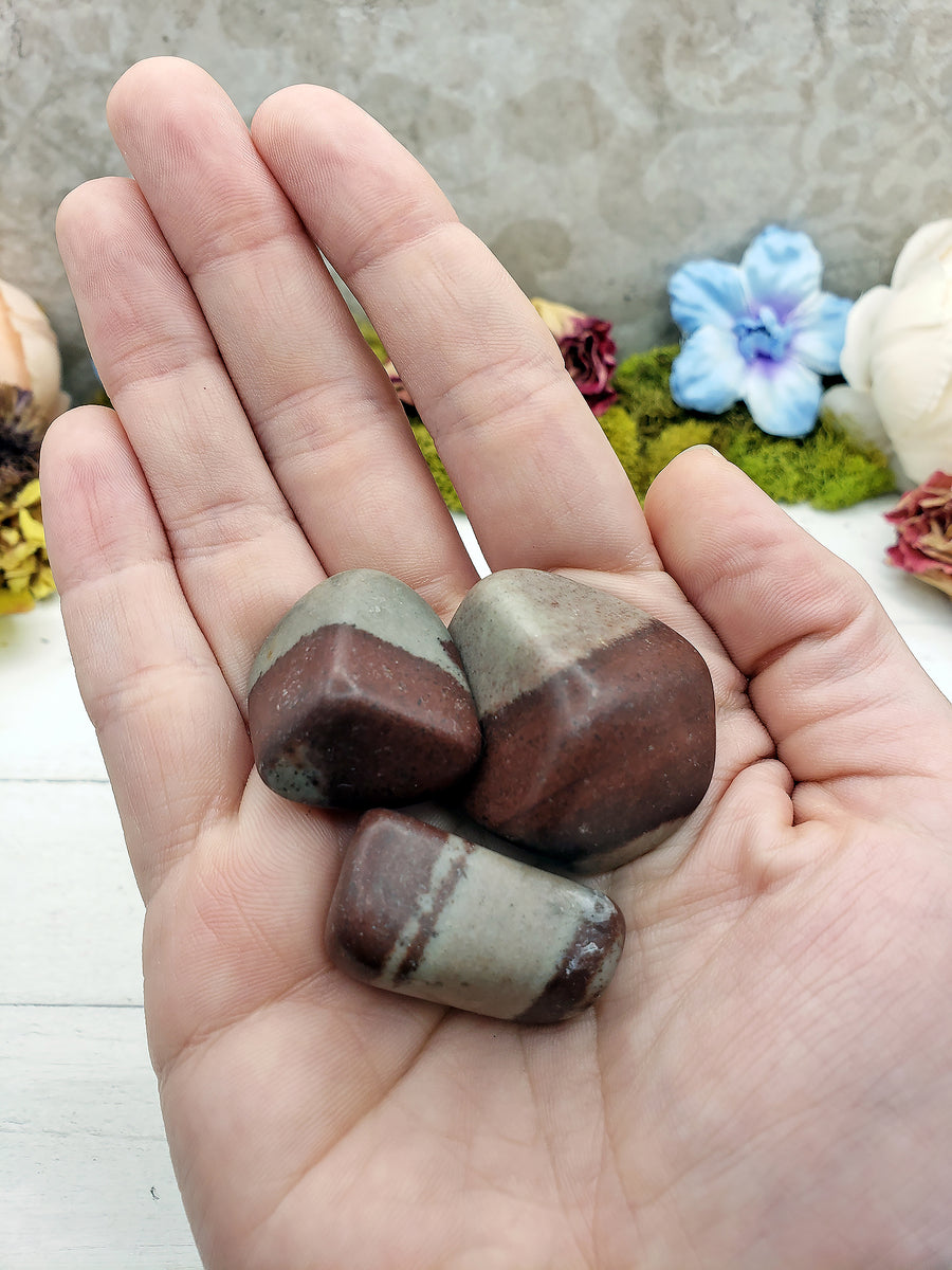shiva lingam stone pieces in hand