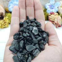 hand holding 3 ounces of black tourmaline chips