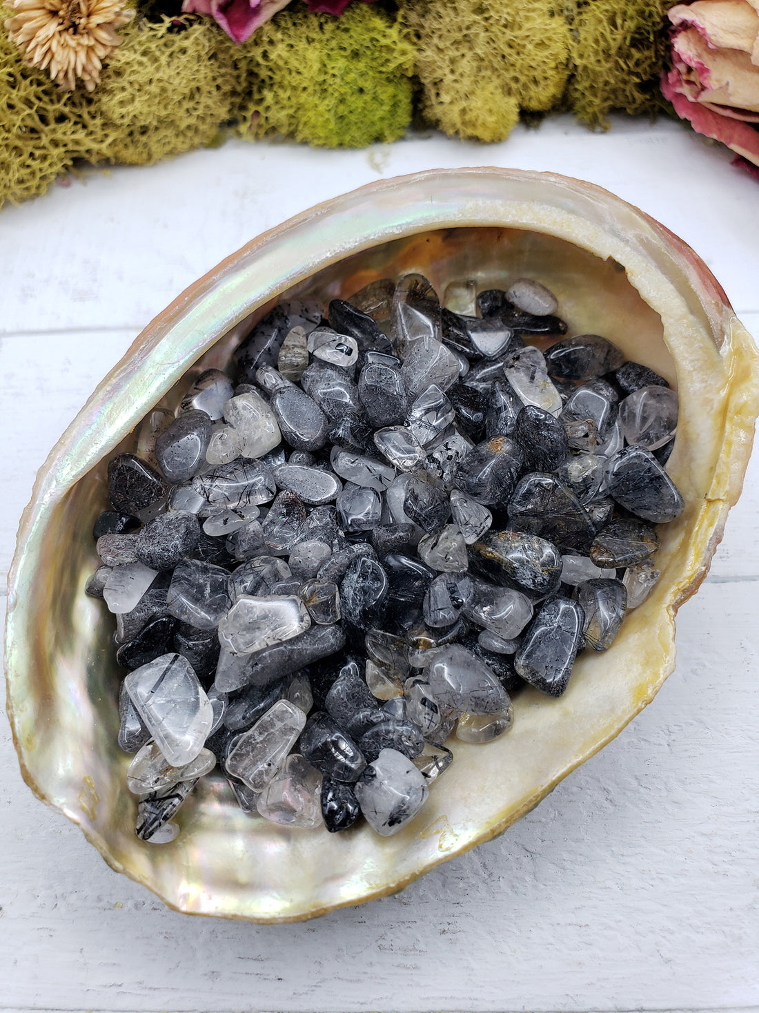 three ounces of black tourmaline rutilated quartz in abalone shell