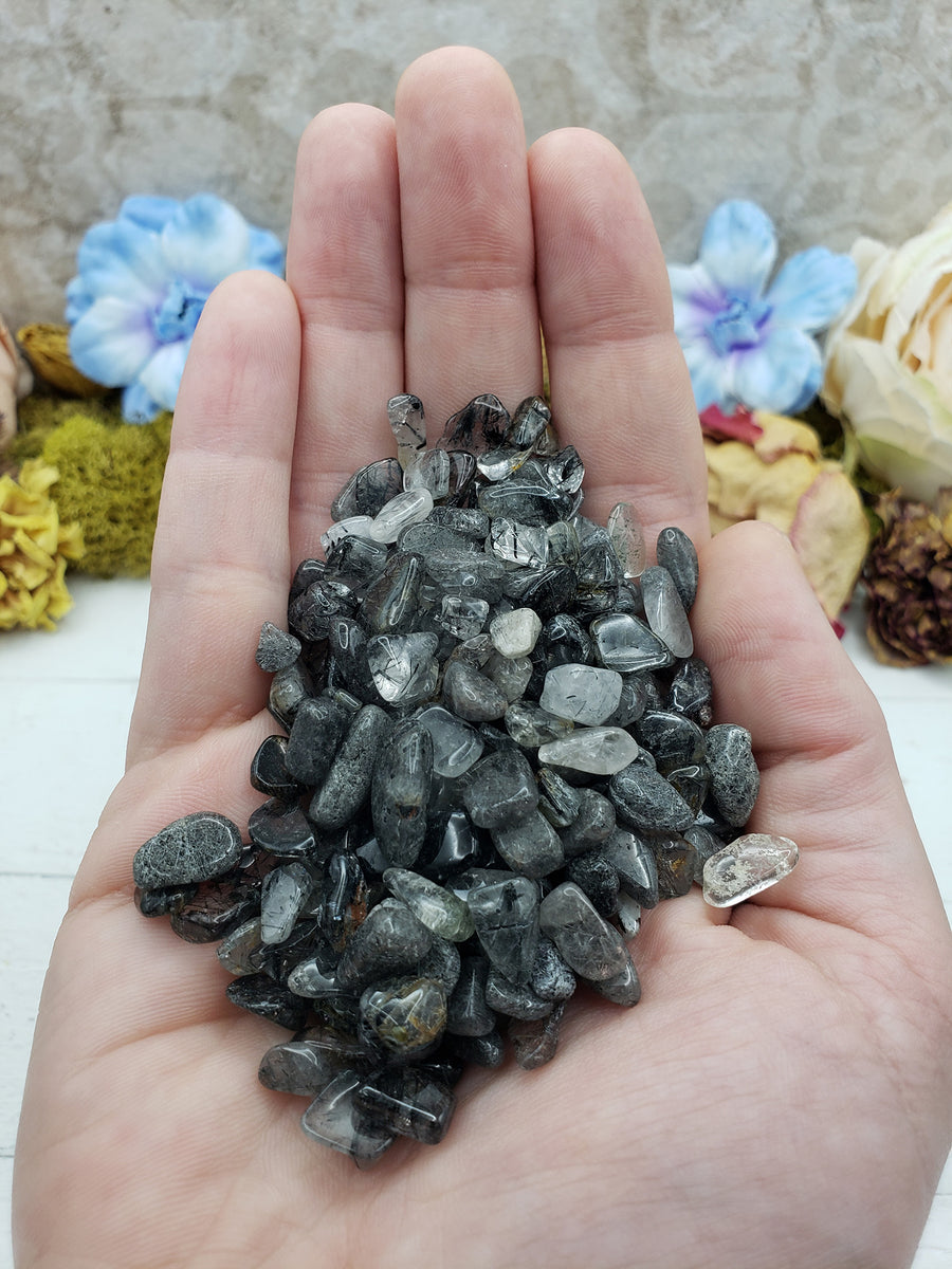 three ounces of black tourmaline rutilated quartz in hand