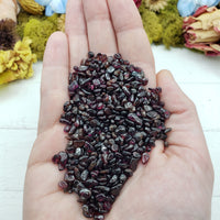 Three ounces of garnet stone chips in hand