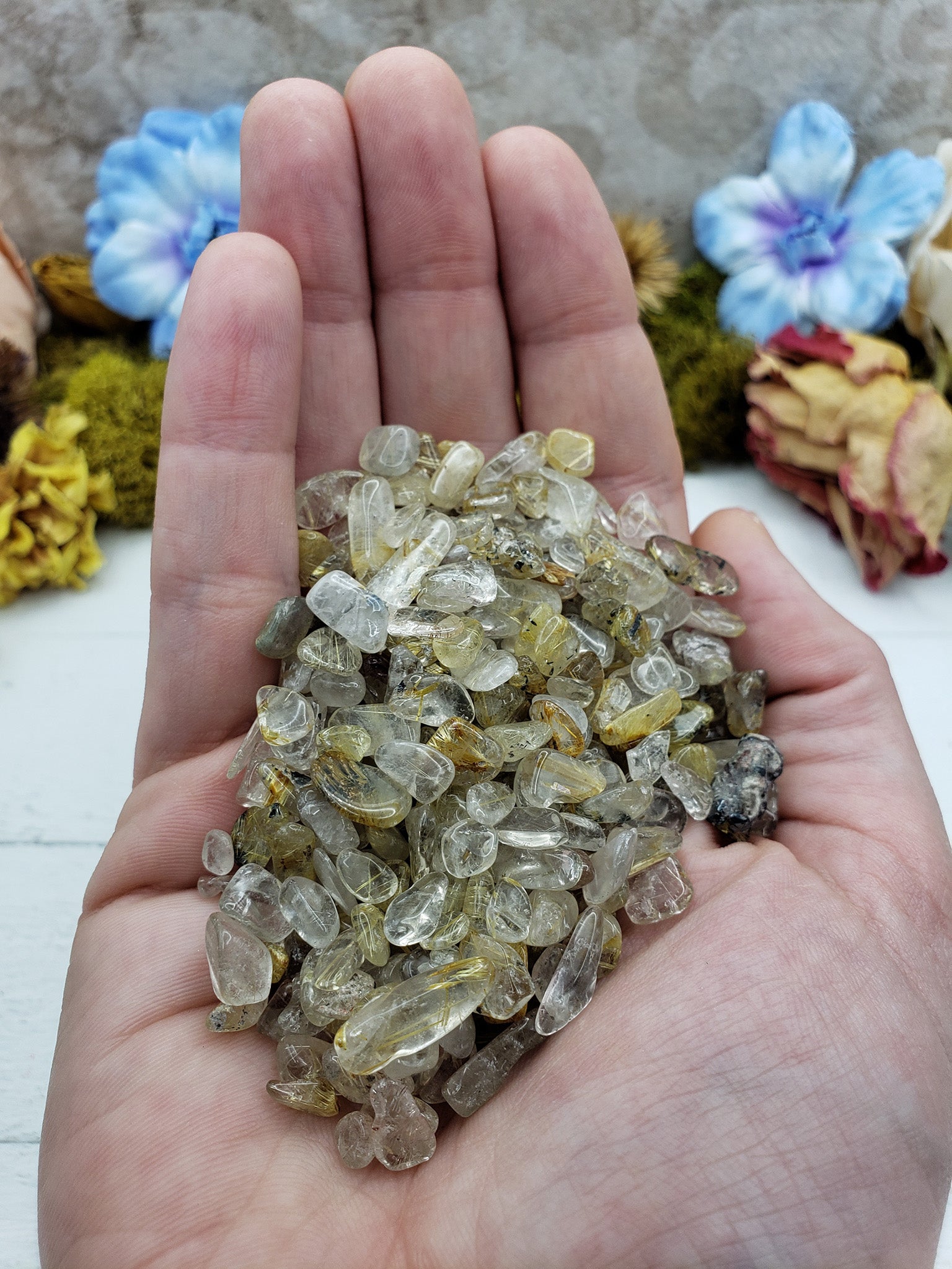 Three ounce gold rutile quartz chips in hand