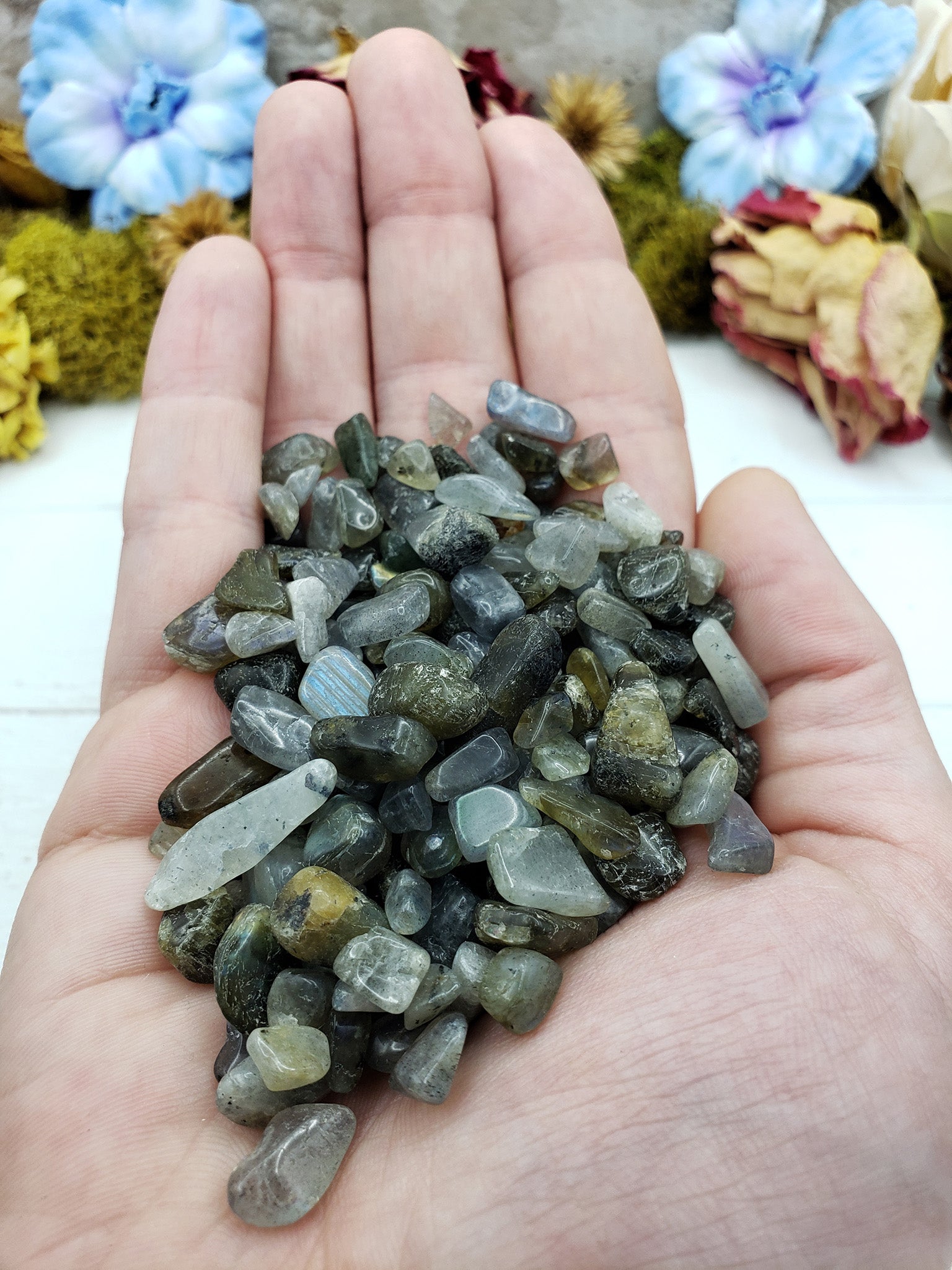 Three ounces of labradorite crystal chips in hand