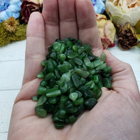 Hand holding three ounces of nephrite jade chips