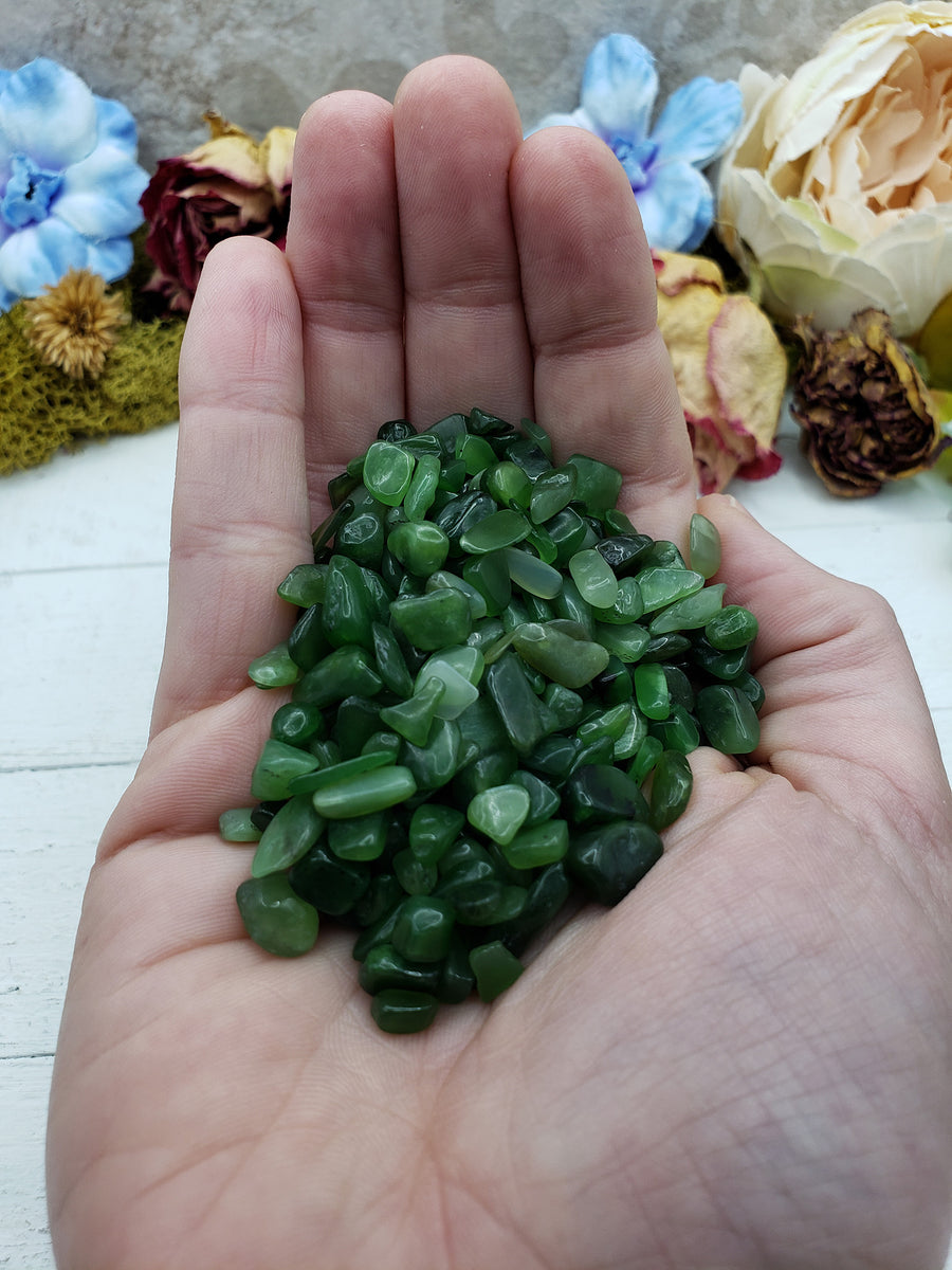 Hand holding three ounces of nephrite jade chips