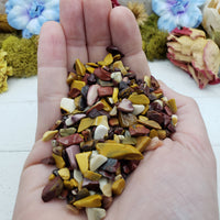 Hand holding thee ounces of mookaite jasper chips
