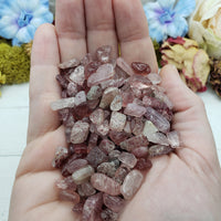 three ounces of strawberry quartz chips in hand