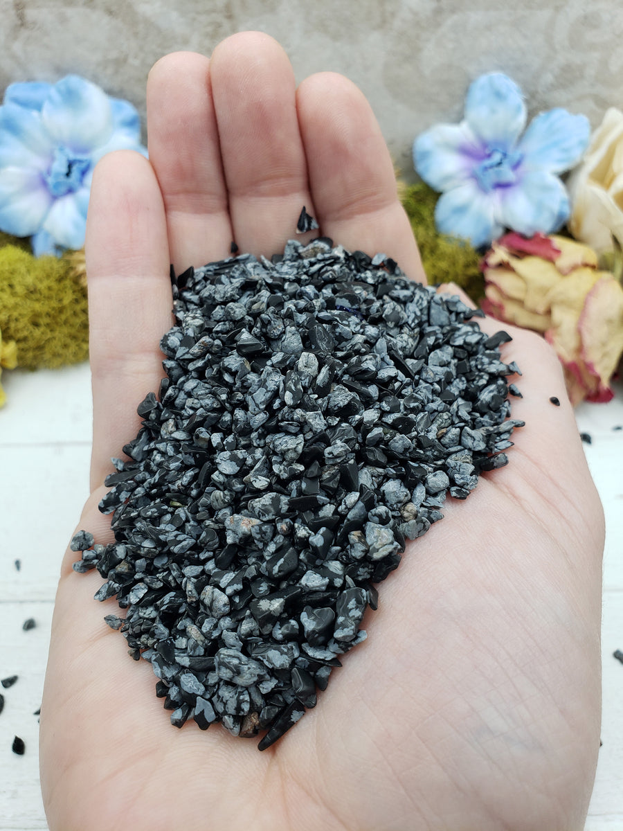 hand holding three ounces of snowflake obsidian chips