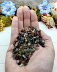 Three ounces of mixed multi tourmaline crystal chips in hand