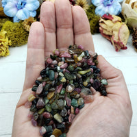 Three ounces of mixed multi tourmaline crystal chips in hand