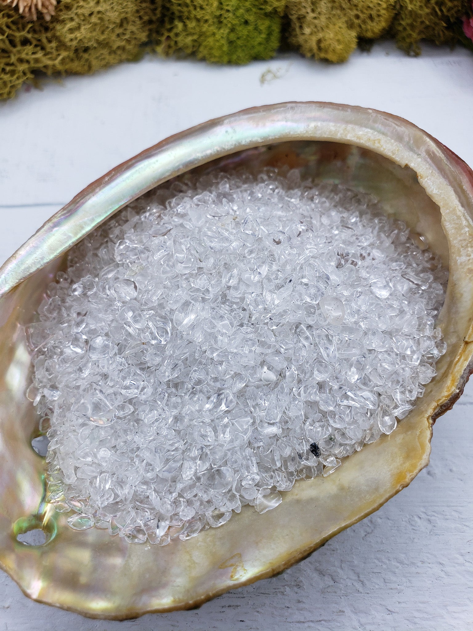 three ounces of quartz crystal chips in abalone shell