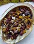 Three ounces of mookaite crystal chips in abalone shell