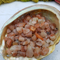 three ounces of sunstone chips in abalone shell