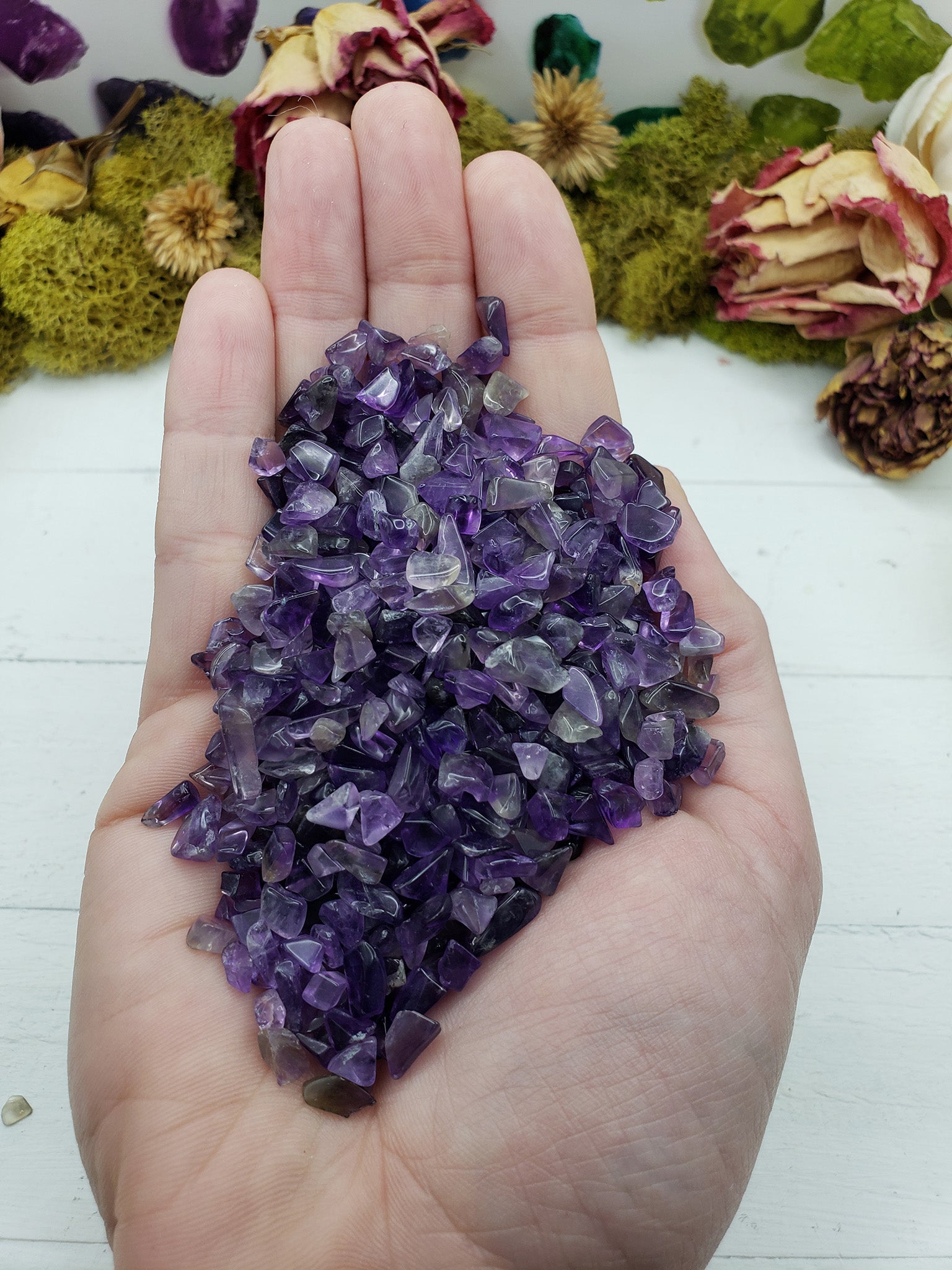 four ounces of amethyst crystal chips in hand