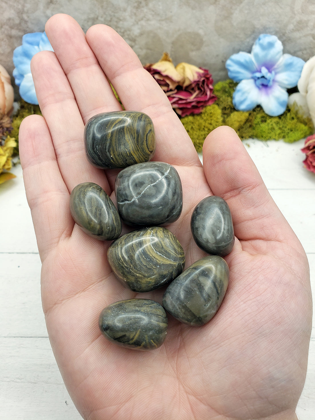 Camouflage jasper stone pieces in hand