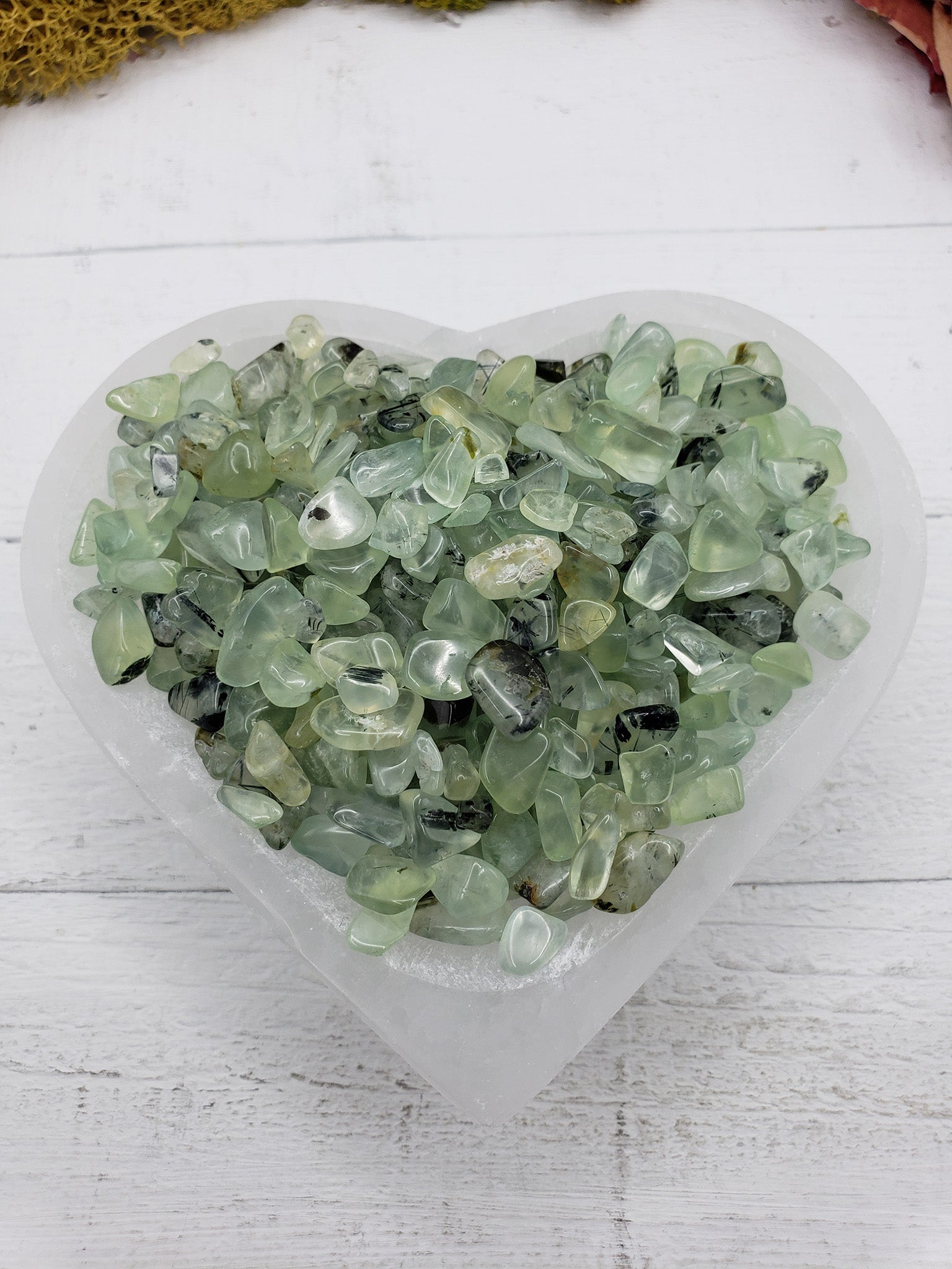 Five ounces of prehnite chips in selenite bowl