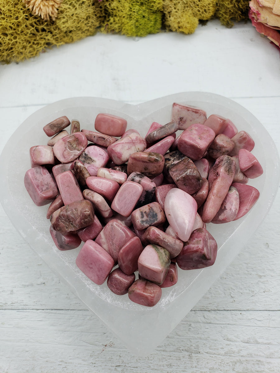Five ounces of rhodonite chips in selenite bowl