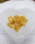 six grams of amber crystal chips in selenite bowl