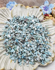 Seven ounces of larimar crystal chips on floral display prop dish