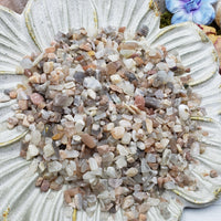 Seven ounces of moonstone chips on floral dish display