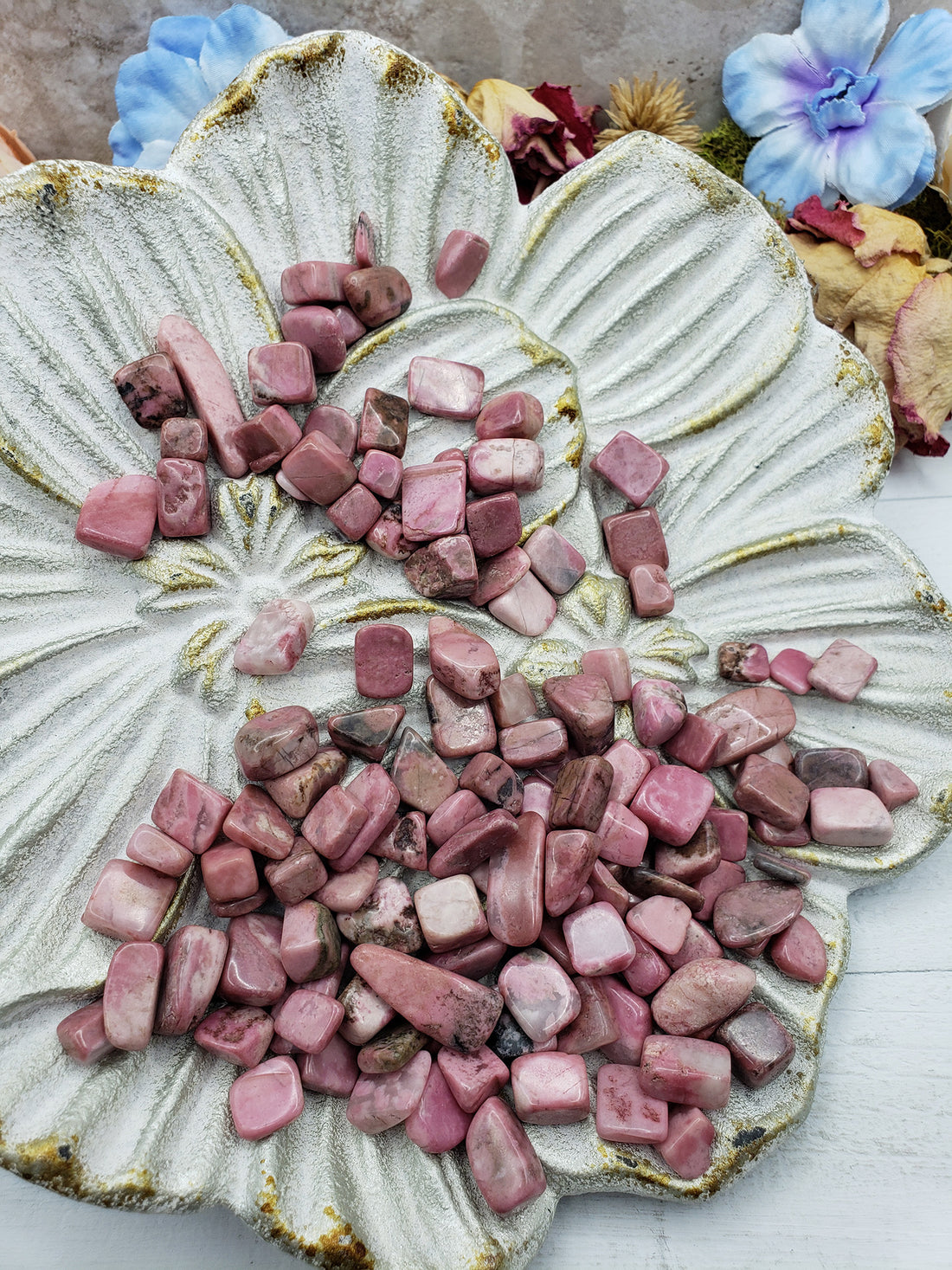 Seven ounces of rhodonite crystal chips on floral dish display