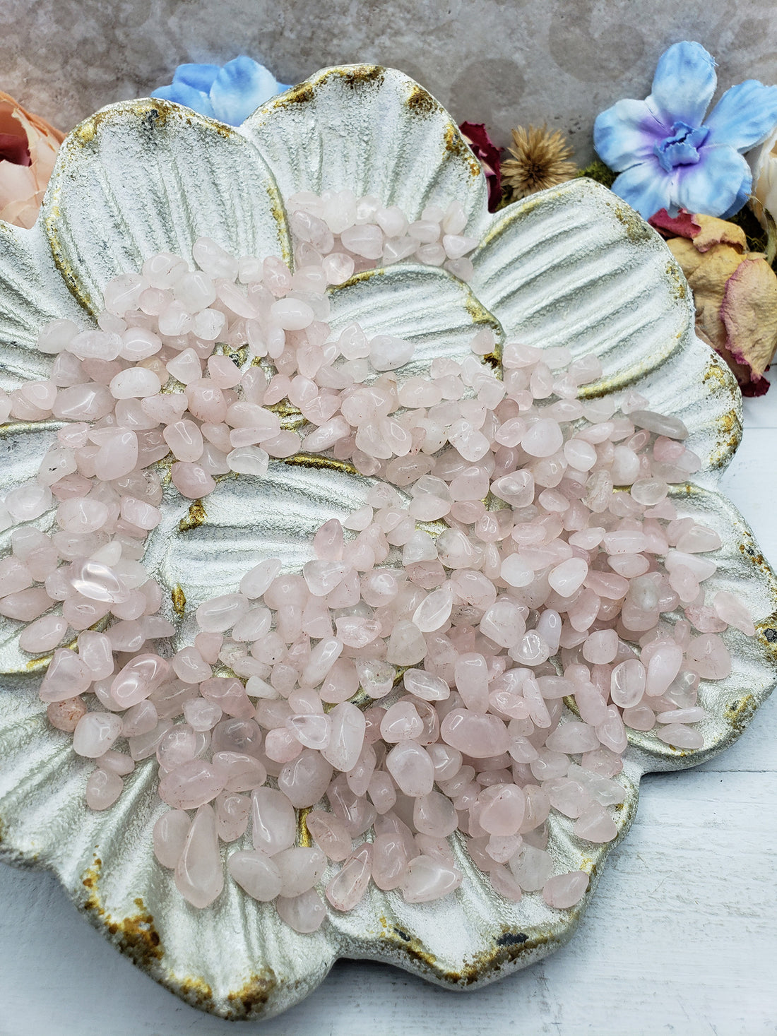 seven ounces of rose quartz chips on floral dish display