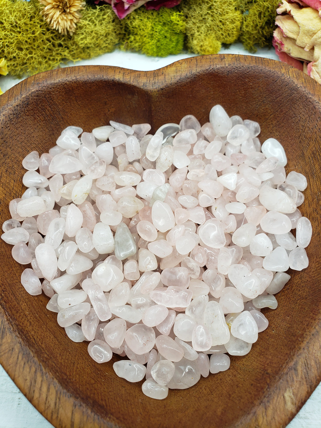 eight ounces of rose quartz stone chips in wooden bowl