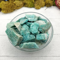 Collection of rough amazonite stones in bowl