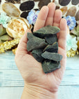 Hand holding rough bloodstone crystal pieces