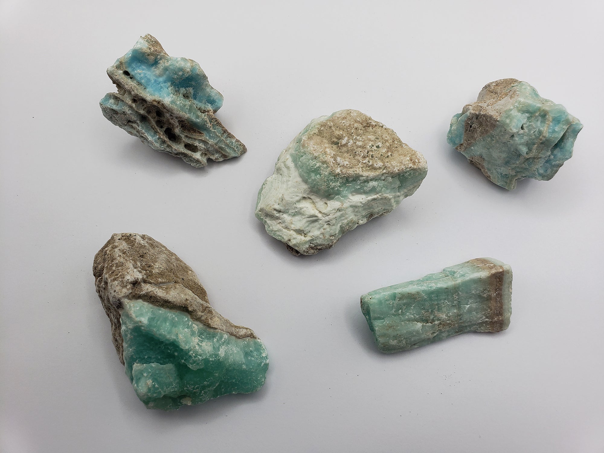 rough blue aragonite crystals on white background