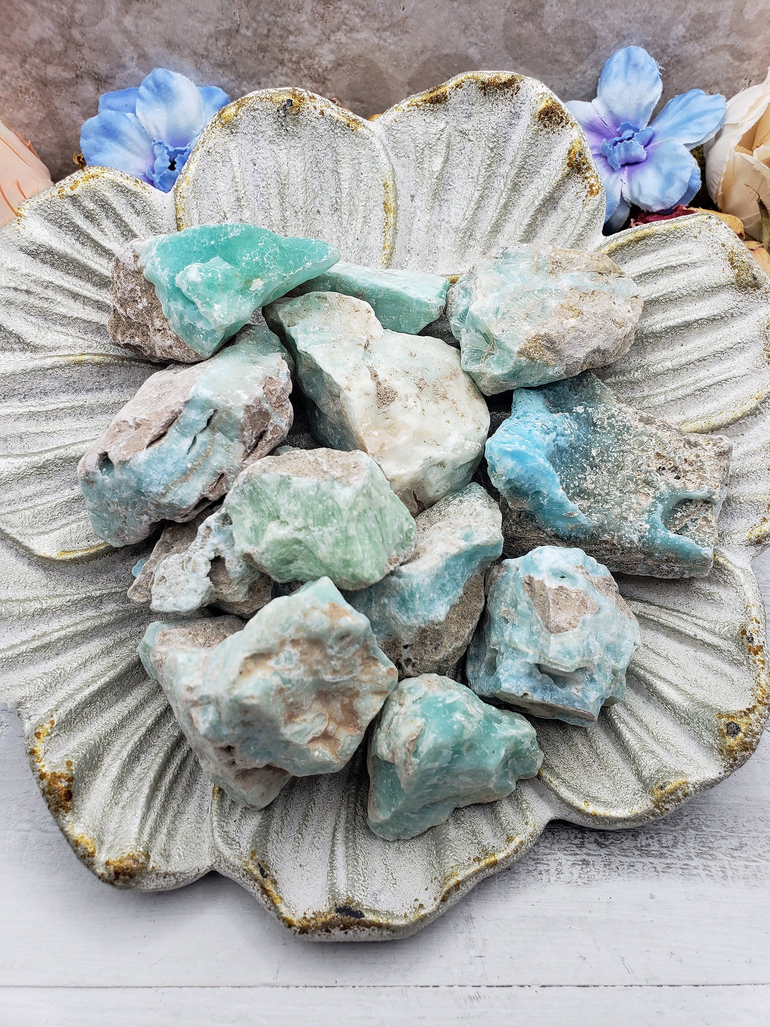 Floral dish with several rough blue aragonite stones