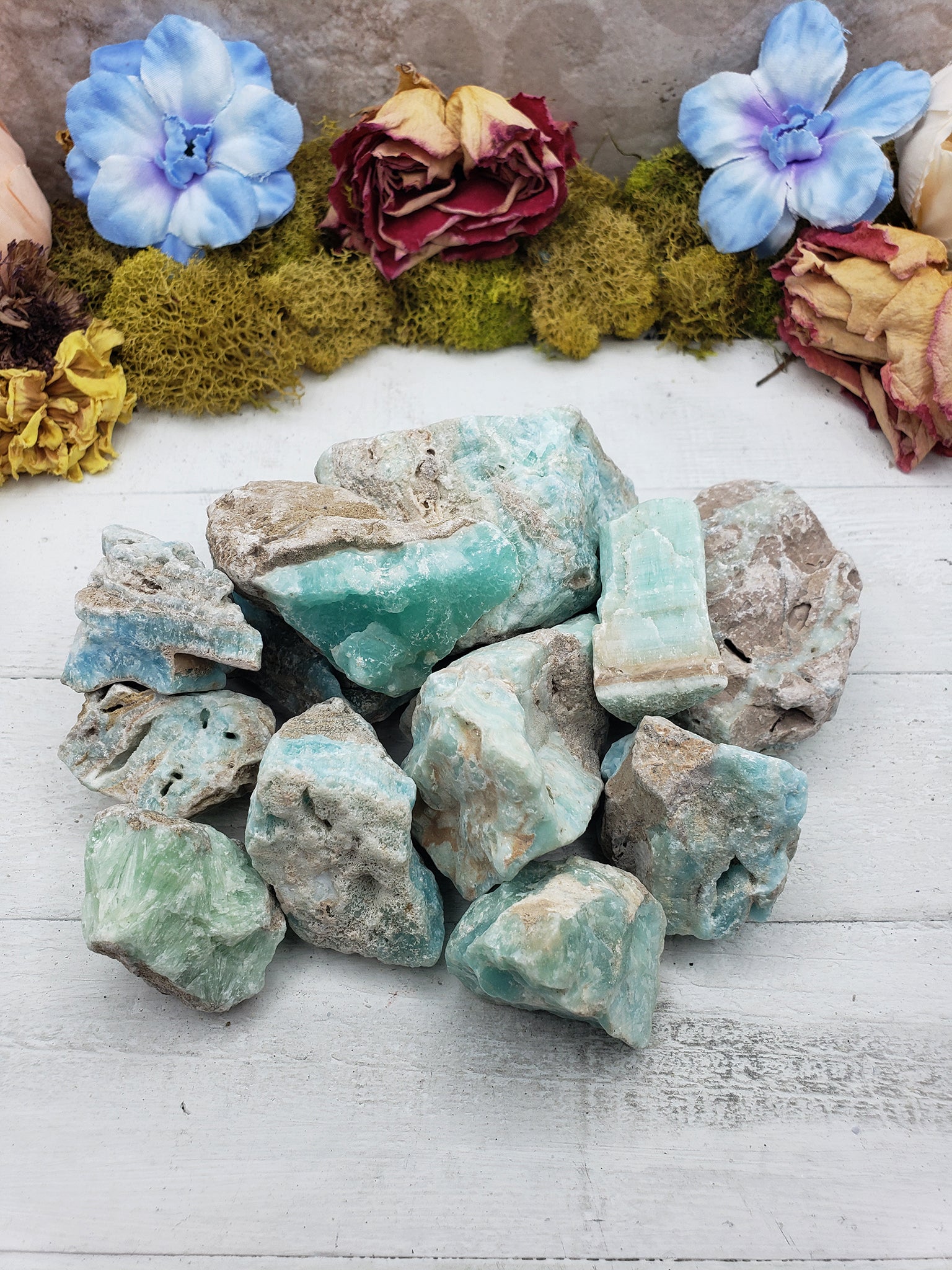 Collection of rough blue aragonite on display
