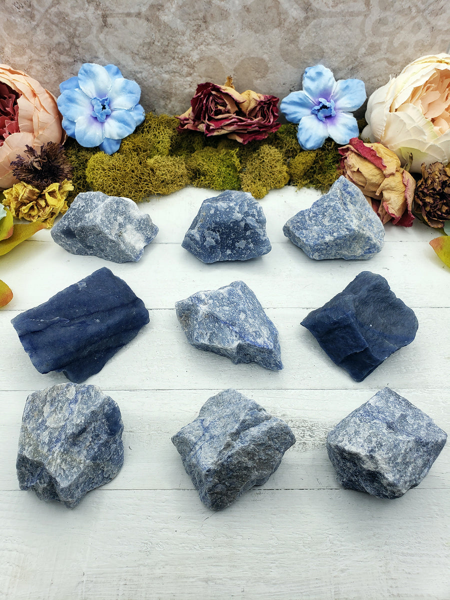 nine rough blue quartz stones on display