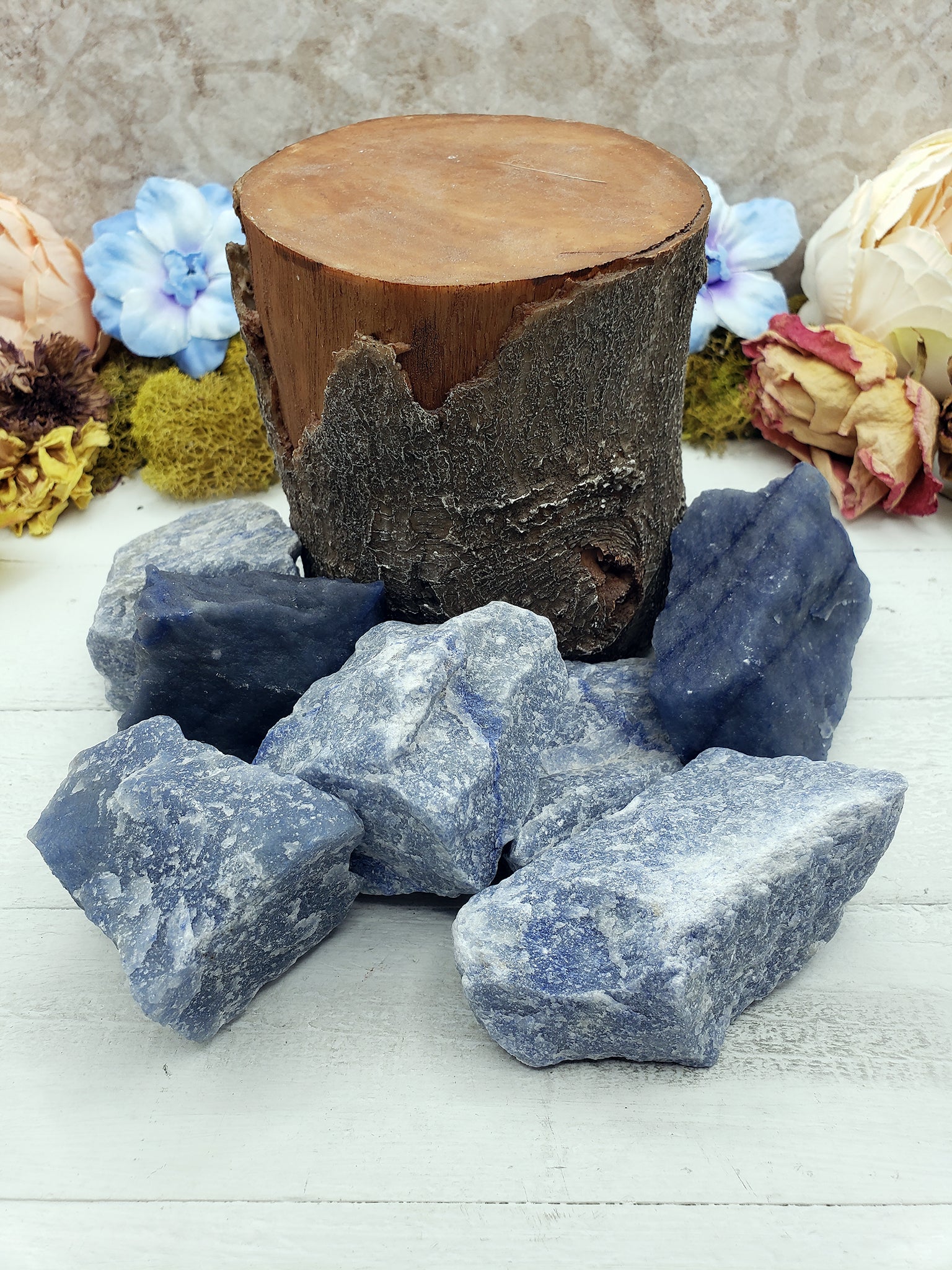 log prop surrounded by rough blue quartz stones
